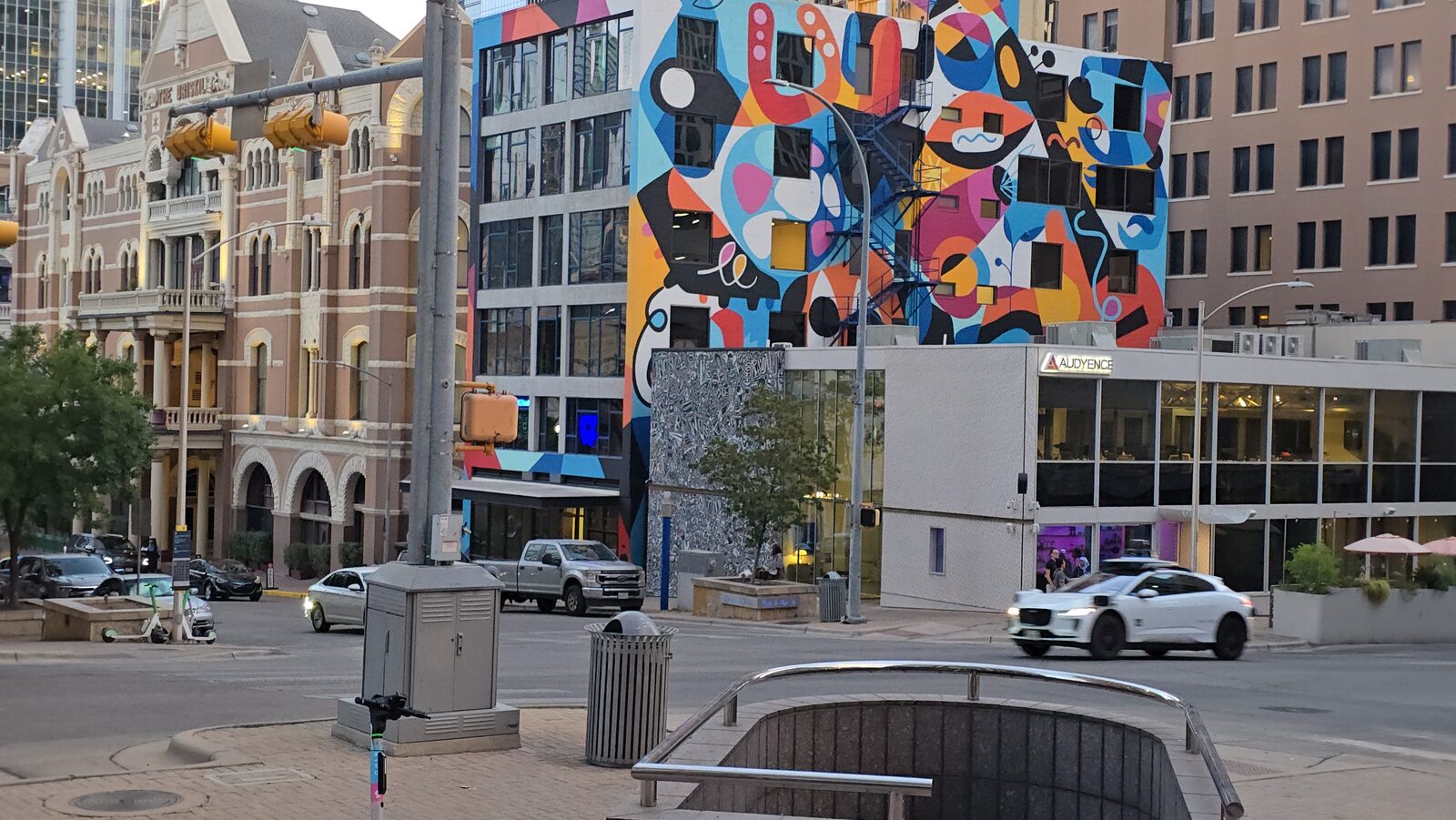 A large geometric mural on a downtown Austin building at dusk
